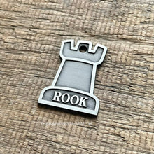 Load image into Gallery viewer, Dog ID tag shaped like a chess rook piece with the name Rook engraved, personalised deep engraved metal pet tag with a clean minimal design.