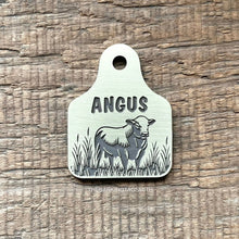 Load image into Gallery viewer, Dog ID tag shaped like a livestock ear tag with cow design deep engraved on metal tag, personalised engraved pet tag with the name Angus