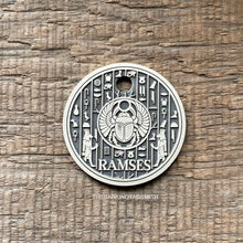 Load image into Gallery viewer, Dog ID tag with Egyptian scarab and hieroglyph design deep engraved on round metal tag, personalised engraved pet tag featuring Ramses.