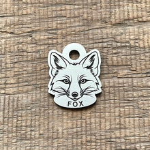 Load image into Gallery viewer, Dog ID tag shaped like a fox head with detailed deep engraved fox face design, personalised engraved metal pet tag for wildlife and nature lovers.