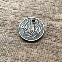 Load image into Gallery viewer, Dog ID tag with swirling galaxy design and engraved name, personalised deep engraved metal pet tag with cosmic space pattern.