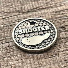 Load image into Gallery viewer, Personalised golf ball dog ID tag with engraved golf ball dimple texture and golf green design in brushed silver metal on rustic wood background