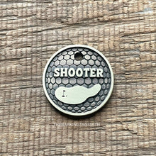 Load image into Gallery viewer, Personalised golf ball dog ID tag with engraved golf ball dimple texture and golf green design in brushed silver metal on rustic wood background