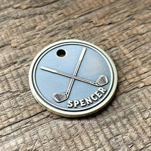 Load image into Gallery viewer, Dog ID tag with crossed golf clubs deep engraved on round metal tag, personalised engraved pet tag for golf lovers with the name Spencer.