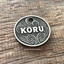 Load image into Gallery viewer, Dog ID tag with koru and fern design and engraved name Koru, personalised deep engraved metal pet tag inspired by New Zealand patterns.