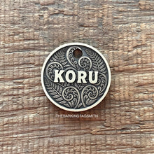 Load image into Gallery viewer, Dog ID tag with koru and fern design and engraved name Koru, personalised deep engraved metal pet tag inspired by New Zealand patterns.