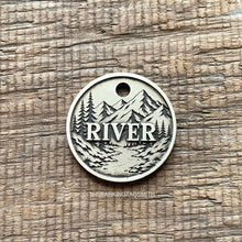 Load image into Gallery viewer, Personalised mountain river dog ID tag with engraved forest, flowing river and mountain landscape in brushed silver metal on rustic wood background
