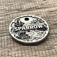Load image into Gallery viewer, Personalised pirate treasure map dog ID tag with engraved sailing ship, skull island, treasure chest and map trail design in brushed silver metal on rustic wood background