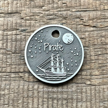 Load image into Gallery viewer, Dog ID tag with pirate sailing ship under a starry night sky deep engraved on round metal tag, personalised engraved pet tag with the name Pirate.