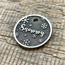 Load image into Gallery viewer, Dog ID tag with snowflake winter design deep engraved on round metal tag, personalised engraved pet tag featuring the name Snowwy.