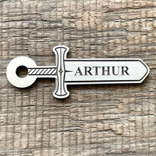 Load image into Gallery viewer, Dog ID tag shaped like a medieval sword with engraved blade design, personalised engraved metal pet tag with the name Arthur.