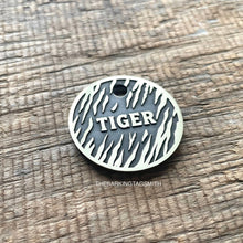 Load image into Gallery viewer, Personalised tiger stripe dog ID tag with engraved tiger fur pattern and raised Tiger name in brushed silver metal on rustic wood background