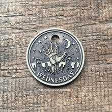 Load image into Gallery viewer, Dog ID tag with zombie hand rising from a graveyard deep engraved on round metal tag, personalised engraved pet tag inspired by Wednesday gothic style.